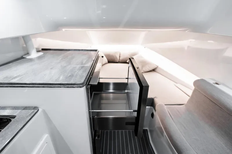 Slide: The Image of Manufacturer Provided Image: Interior of 2026 Contender 44 Fisharound boat with modern kitchen and seating area. - 10