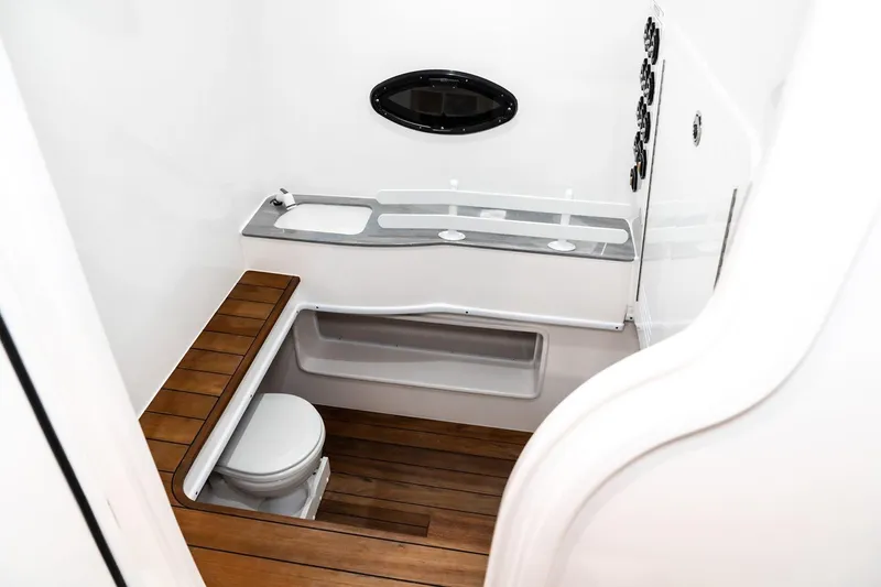 Slide: The Image of Manufacturer Provided Image: 2026 Contender 44 ST boat interior with wooden flooring and compact bathroom. - 16
