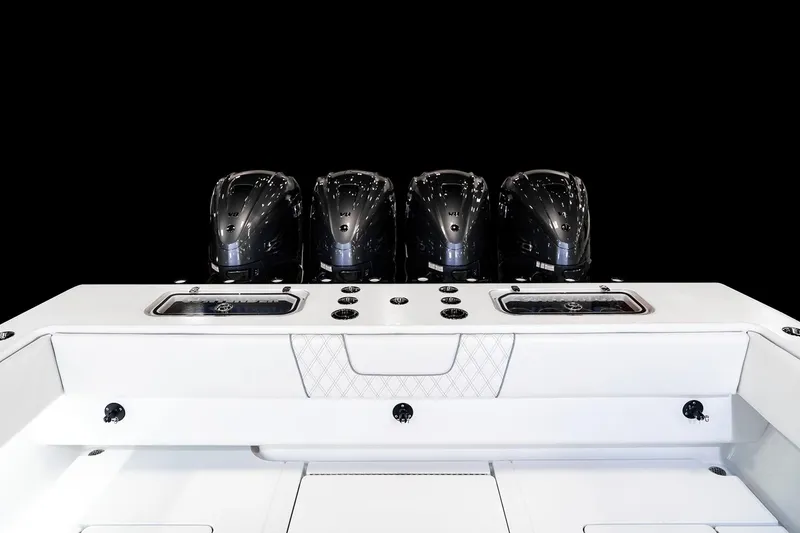 Slide: The Image of Manufacturer Provided Image: 2026 Contender 44 ST boat with four powerful outboard engines, sleek white design. - 15
