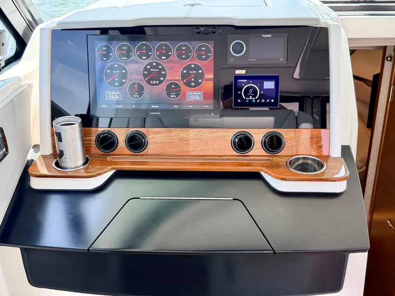 Slide: The Image of The image shows the dashboard of a 2022 Tiara Yachts 43 LE with modern instruments. - 24