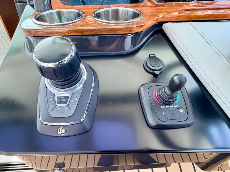 Slide: The Image of Close-up of the helm station on a 2022 Tiara Yachts 43 LE with modern controls. - 21