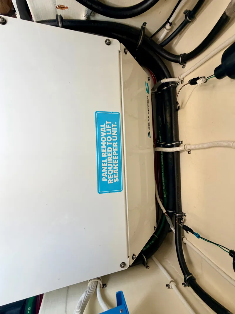 Slide: The Image of An engine room with a Seakeeper stabilizer, surrounded by cables and pipes. - 48