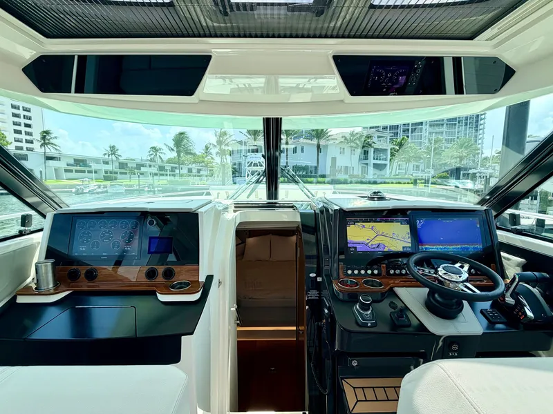 Slide: The Image of The cockpit of a 2022 Tiara Yachts 43 LE with modern navigation systems and controls. - 16