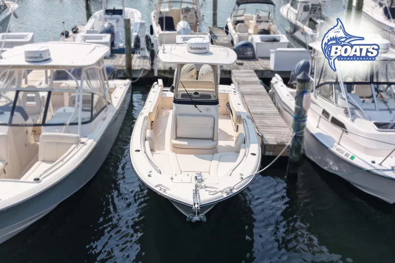 Slide: The Image of 2024 Grady-White Fisherman 257 boat docked among other vessels at a marina. - 3