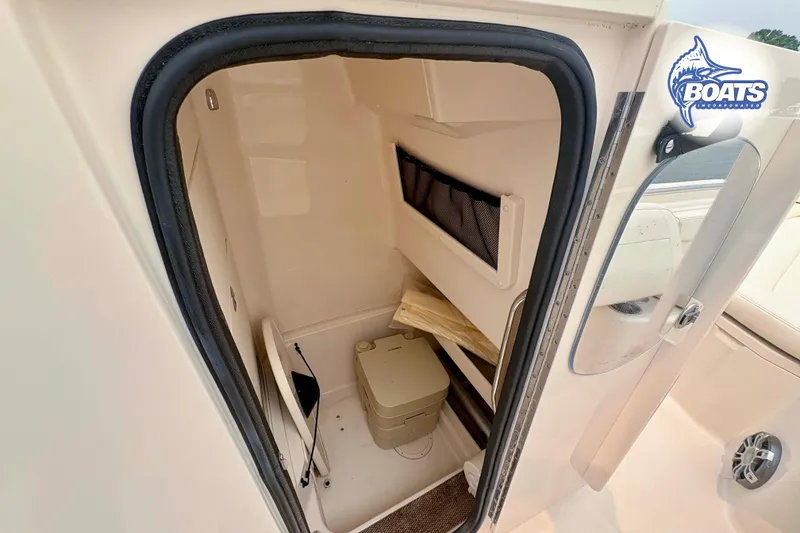 Slide: The Image of 2024 Grady-White Fisherman 257 boat interior with compact restroom and storage space. - 9