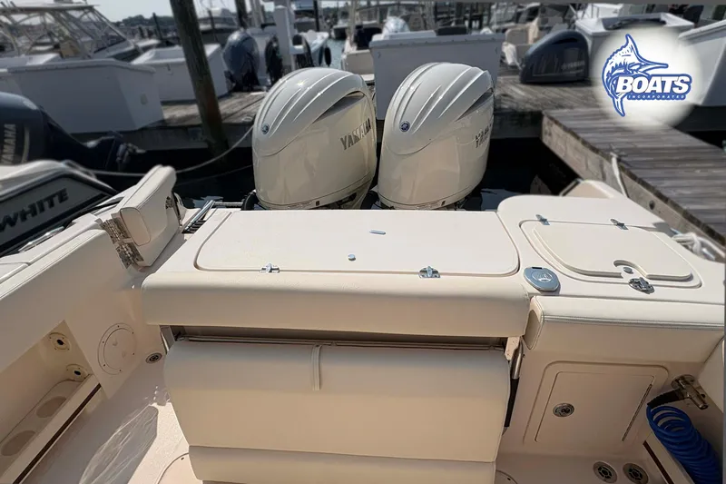 Slide: The Image of 2024 Grady-White Fisherman 257 boat with twin Yamaha engines at a marina. - 13