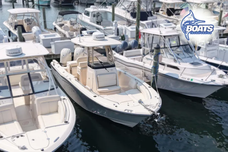 Slide: The Image of 2024 Grady-White Fisherman 257 boat docked among other vessels at a marina. - 2