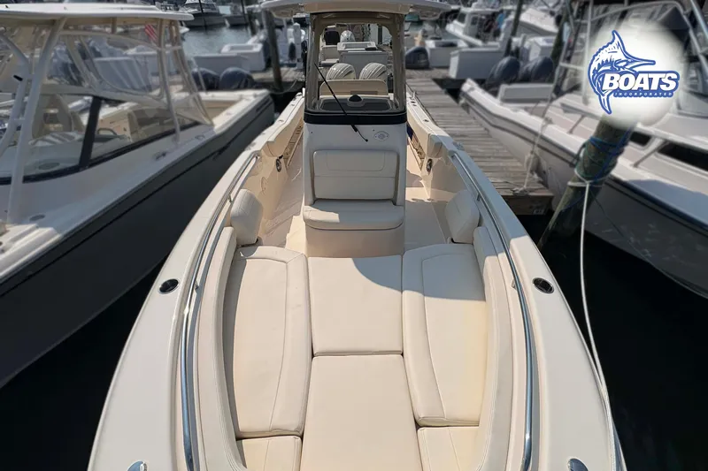 Slide: The Image of 2024 Grady-White Fisherman 257 boat docked, showcasing spacious seating and sleek design. - 5
