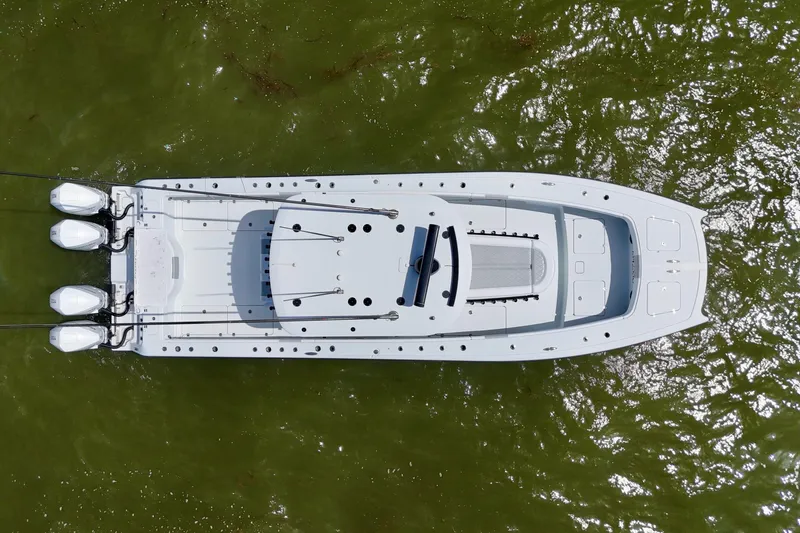 Slide: The Image of Aerial view of 2024 Freeman 38 boat on green water, showcasing sleek design and multiple engines. - 43