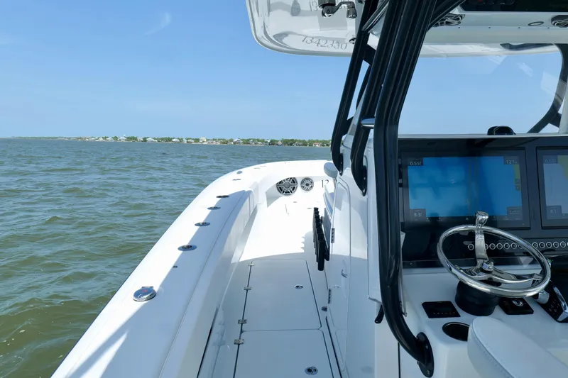 Slide: The Image of 2024 Freeman 38 boat on water, featuring modern navigation controls and sleek design. - 32