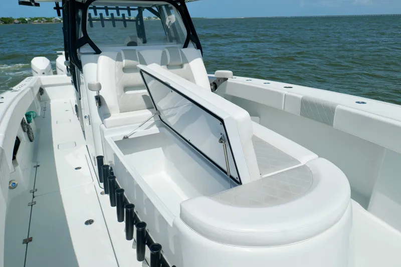 Slide: The Image of 2024 Freeman 38 boat interior with open storage compartment on calm water. - 39