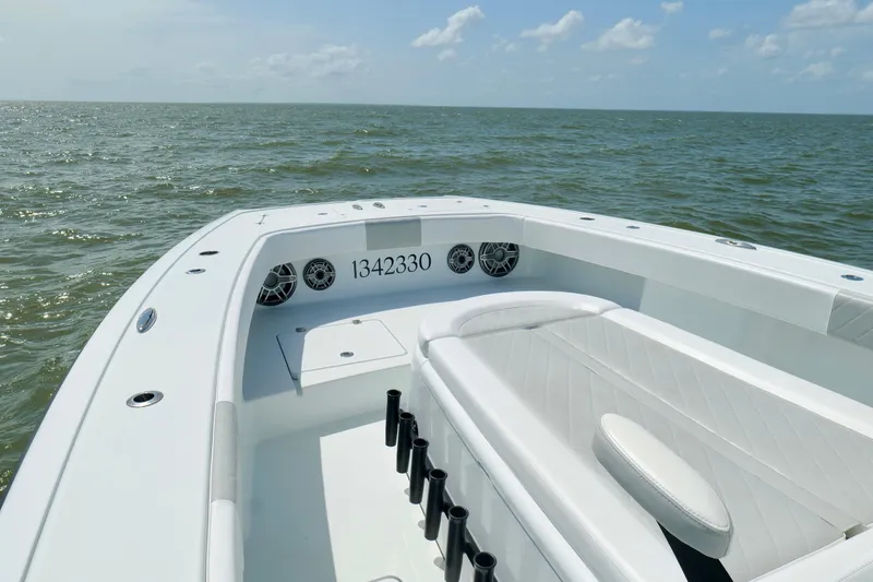 Slide: The Image of 2024 Freeman 38 boat interior with seating, rod holders, and ocean view. - 37