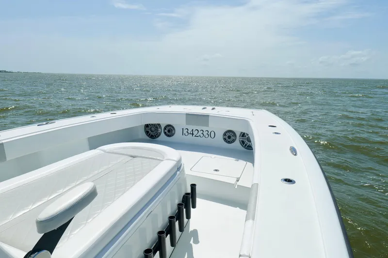 Slide: The Image of 2024 Freeman 38 boat on open water, featuring sleek white deck and seating. - 38