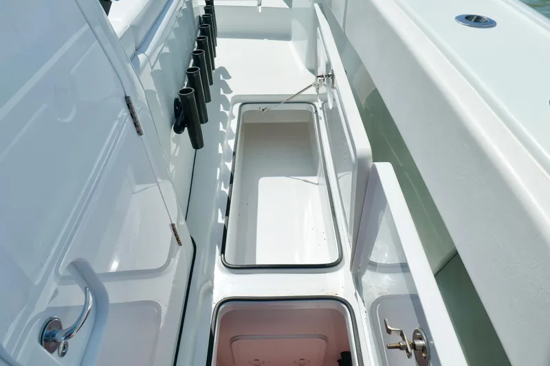 Slide: The Image of 2024 Freeman 38 boat interior with open storage compartments and rod holders. - 36