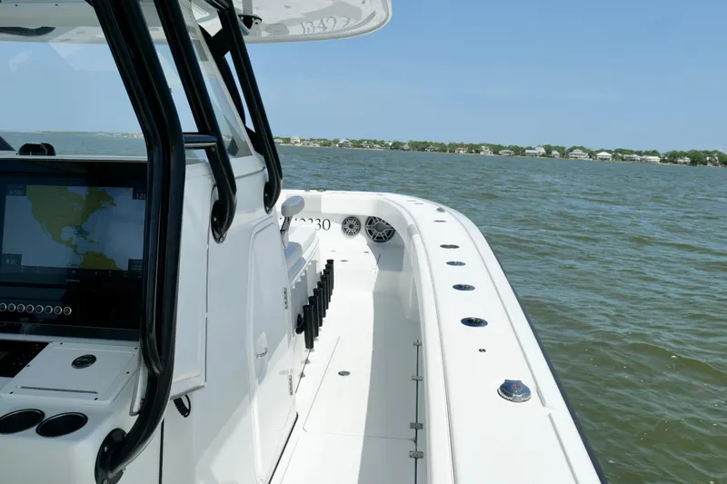 Slide: The Image of 2024 Freeman 38 boat on water, featuring sleek design and advanced navigation system. - 33