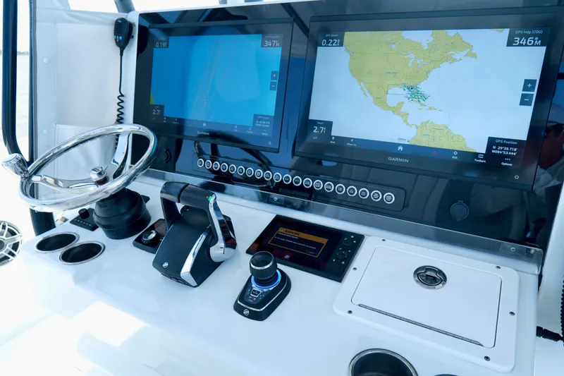 Slide: The Image of 2024 Freeman 38 boat dashboard with dual Garmin navigation screens and steering wheel. - 14