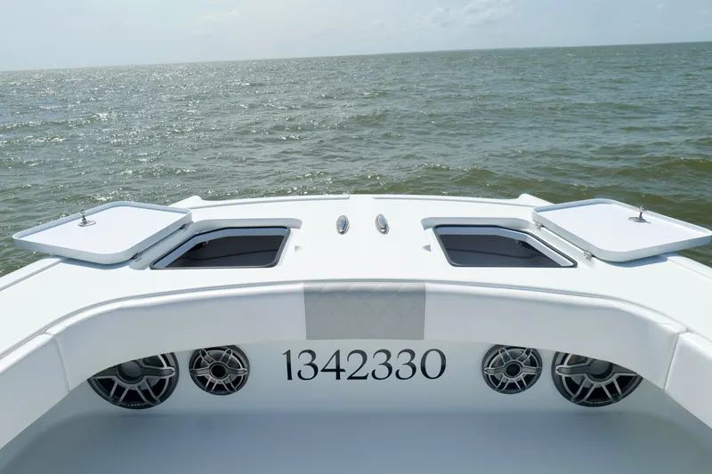 Slide: The Image of Freeman 38 boat deck view, 2024 model, on open water with storage compartments. - 41