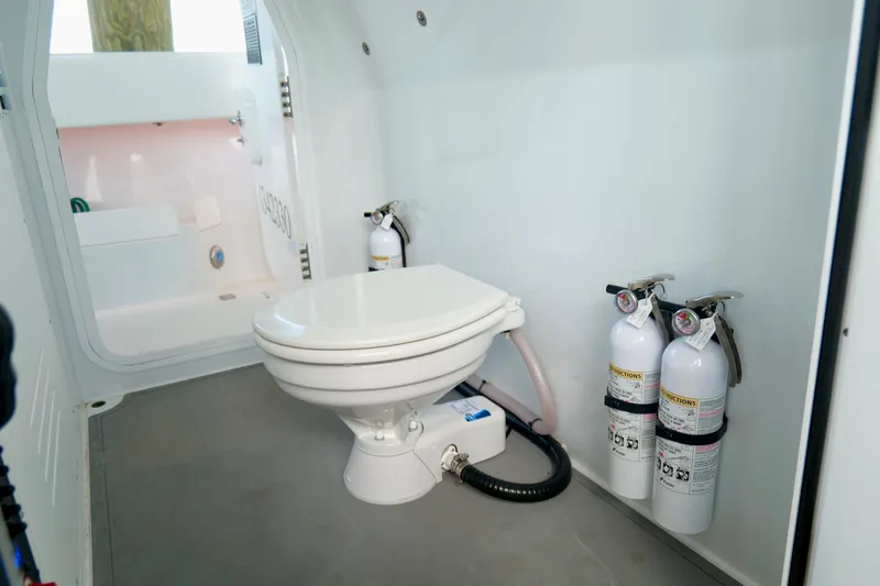 Slide: The Image of 2024 Freeman 38 boat interior with toilet and fire extinguishers. - 34
