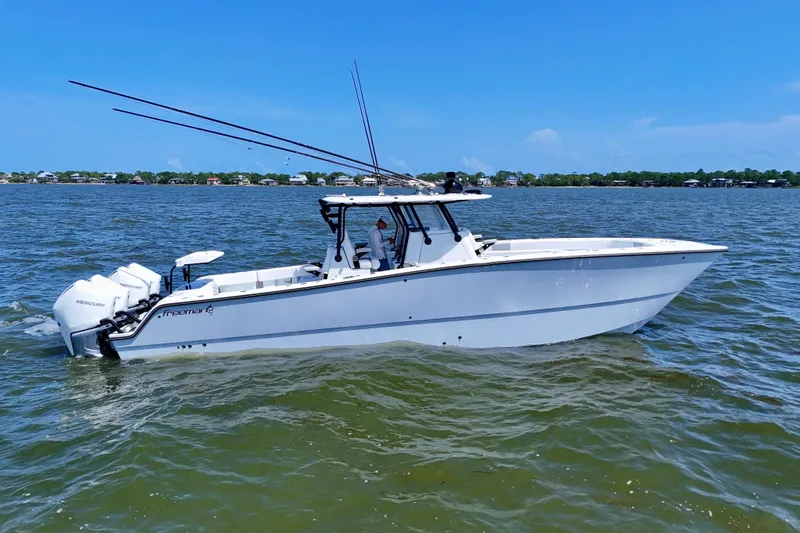The Image of 2024 Freeman 38 boat on water, featuring dual Mercury engines, clear sky background. - 0