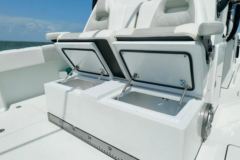Slide: The Image of 2024 Freeman 38 boat with open storage compartments and cushioned seating. - 29