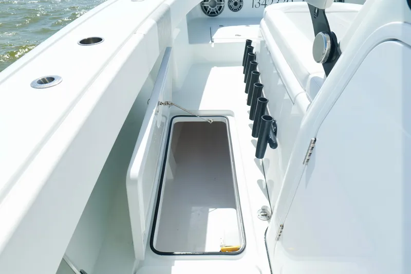 Slide: The Image of 2024 Freeman 38 boat interior with open storage compartment and rod holders. - 35