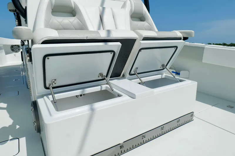 Slide: The Image of 2024 Freeman 38 boat with open storage compartments and white seating. - 28