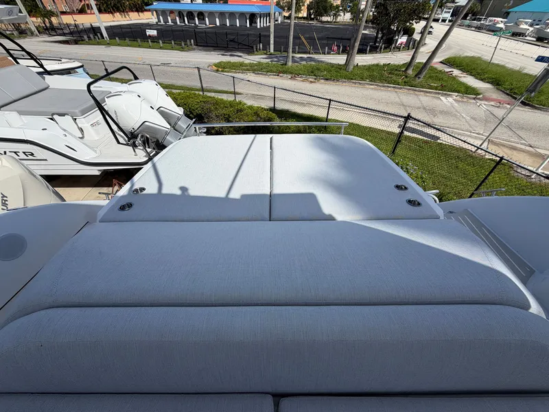 Slide: The Image of Sun deck of a 2027 Azimut A45, featuring cushioned lounging areas, parked outdoors. - 22