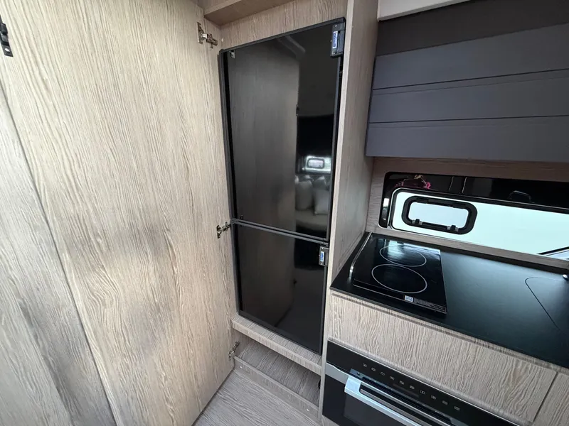 Slide: The Image of Modern kitchen in an Azimut A45 yacht with wood paneling, stove, and oven. - 49