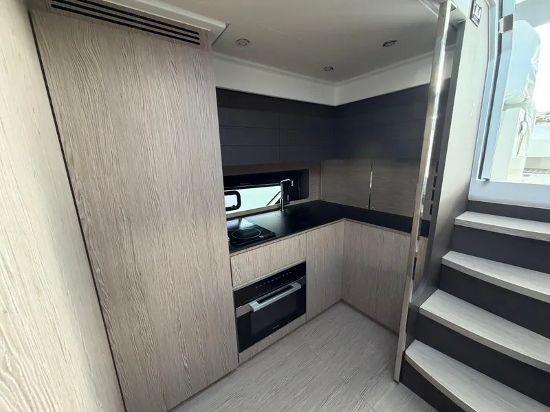 Slide: The Image of Modern kitchen on an Azimut A45 yacht with wood paneling and stairs. - 47