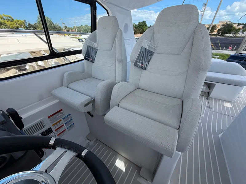 Slide: The Image of Two cushioned captain's chairs in the helm of a modern yacht. - 38