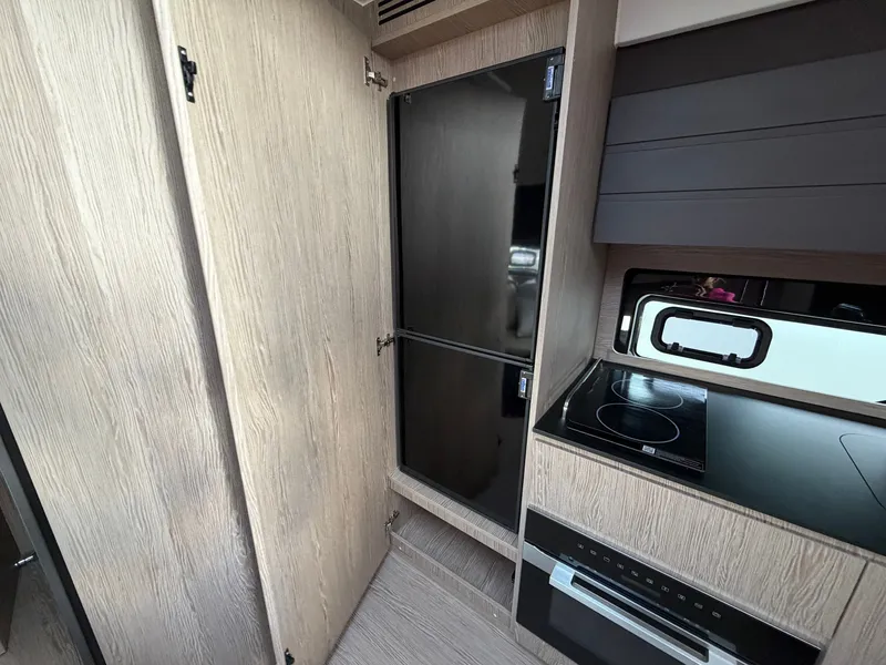 Slide: The Image of Modern kitchen in an Azimut A45 yacht with stove, oven, and refrigerator. - 48