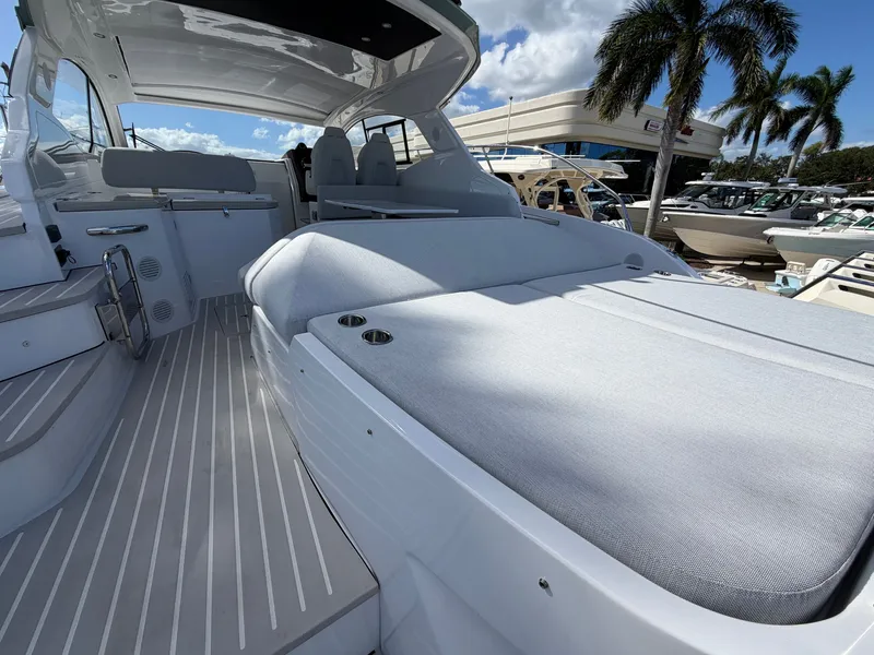 Slide: The Image of The image shows the deck of a 2027 Azimut A45 with sleek seating and palm trees in the background. - 16