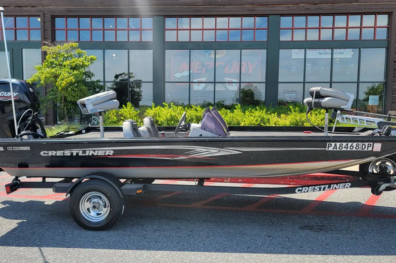 The Image of 2015 Crestliner VT 18 boat on trailer, parked outside a building. - 0