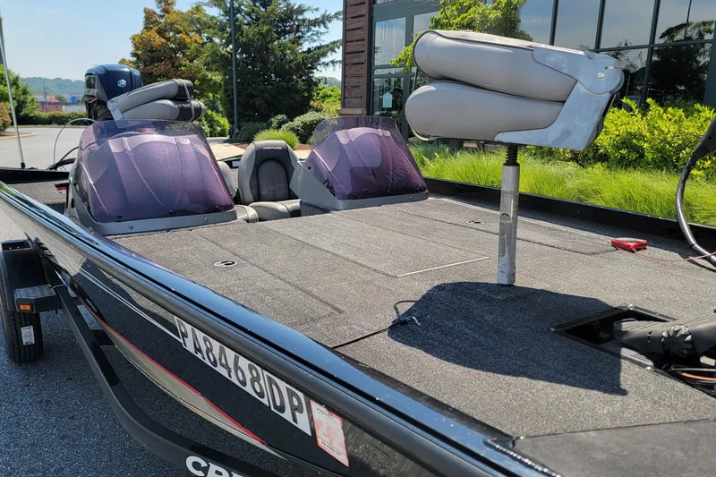 Slide: The Image of 2015 Crestliner VT 18 boat with seating, parked outdoors on a sunny day. - 6