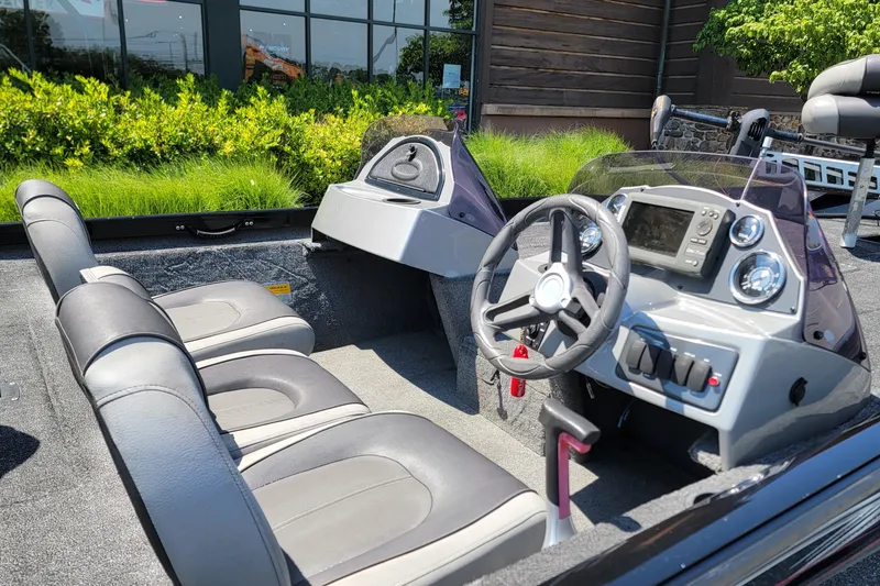 Slide: The Image of 2015 Crestliner VT 18 boat interior with steering wheel and seating, outdoors. - 3