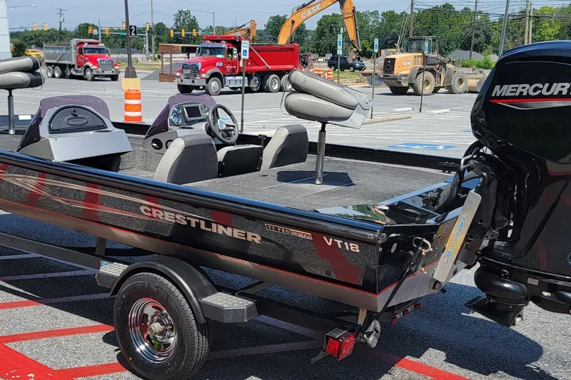 Slide: The Image of 2015 Crestliner VT 18 boat with Mercury engine in a parking lot. - 11
