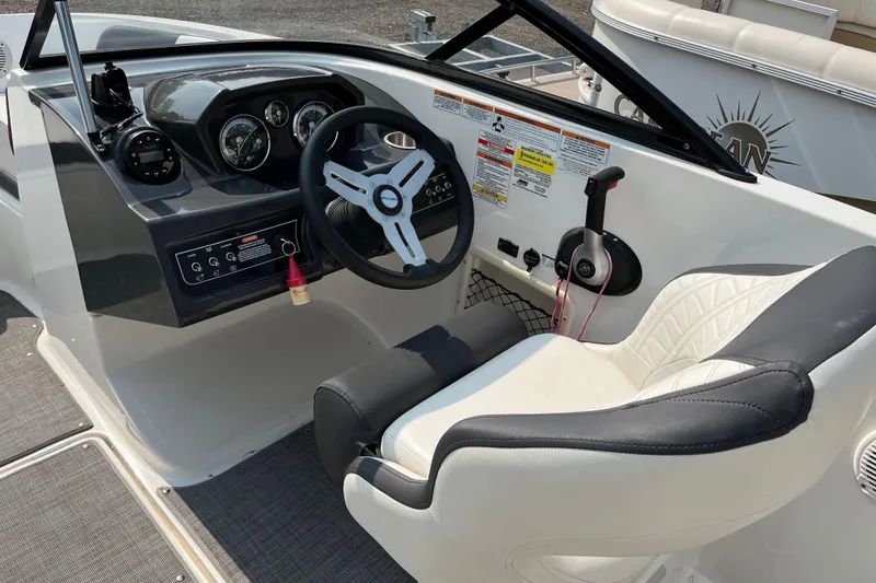 Slide: The Image of 2022 Bayliner VR5 Bowrider I/O cockpit with steering wheel and control panel. - 7