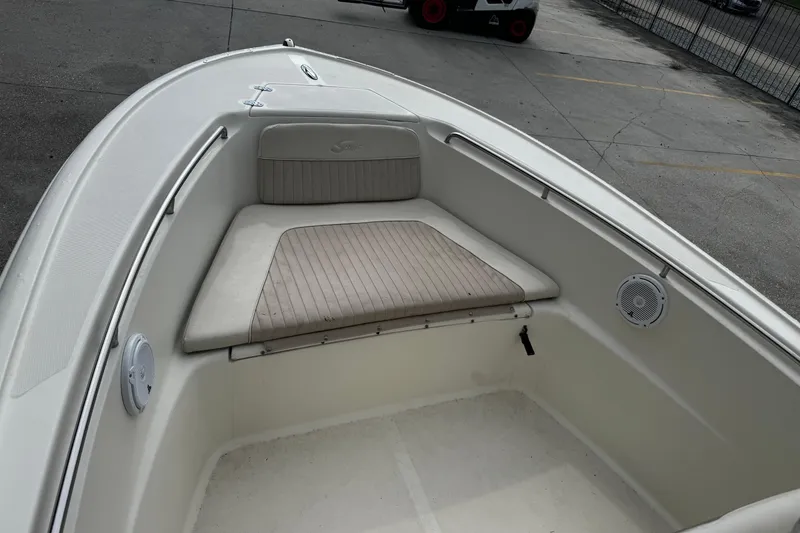 Slide: The Image of 2006 Scout 222 Sportfish boat interior with cushioned seating and speakers. - 16