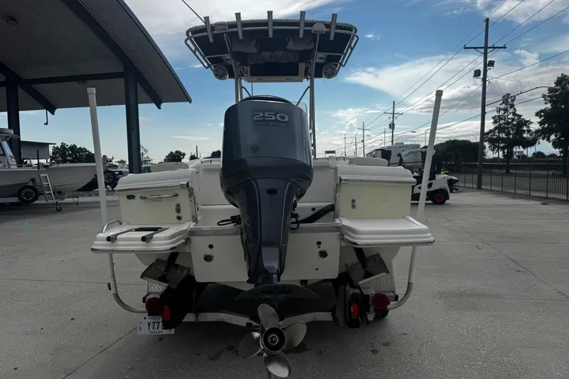 Slide: The Image of 2006 Scout 222 Sportfish boat with powerful outboard motor, parked outdoors. - 3