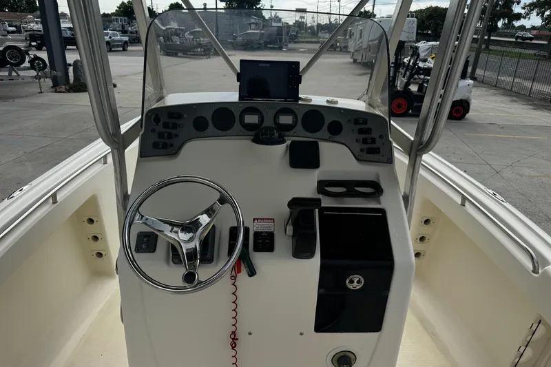 Slide: The Image of 2006 Scout 222 Sportfish boat console with steering wheel and controls. - 10