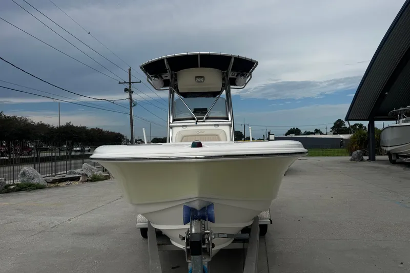 Slide: The Image of 2006 Scout 222 Sportfish boat on trailer, parked outdoors under cloudy sky. - 8