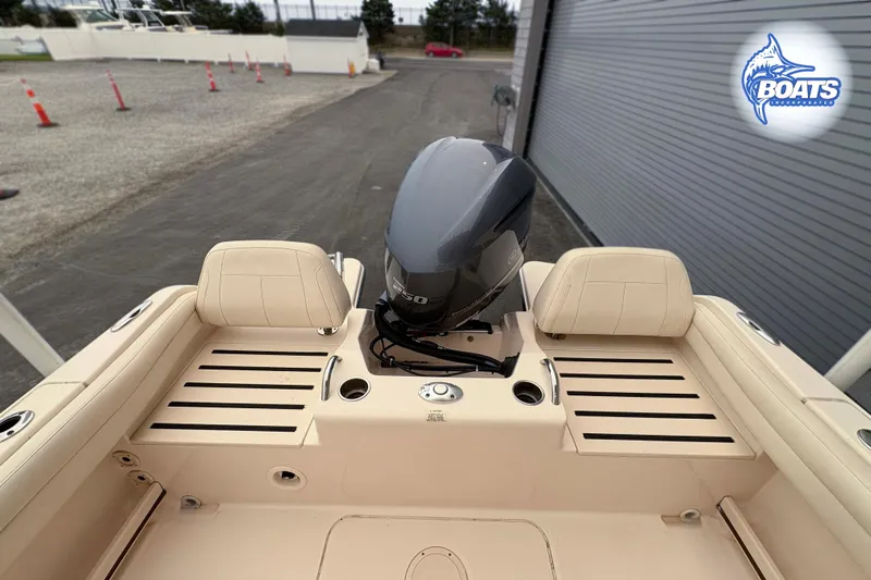 Slide: The Image of 2018 Grady-White Fisherman 216 boat with outboard motor, docked near a warehouse. - 13