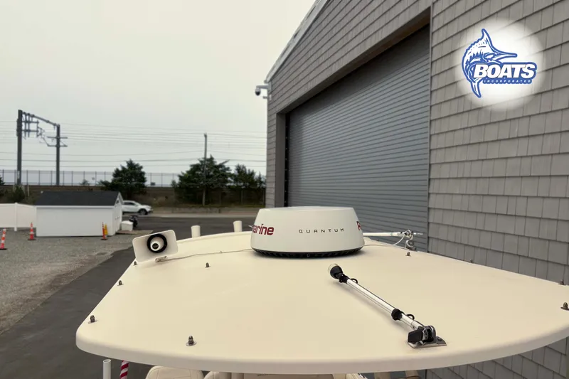 Slide: The Image of 2018 Grady-White Fisherman 216 boat with radar equipment near a building. - 10