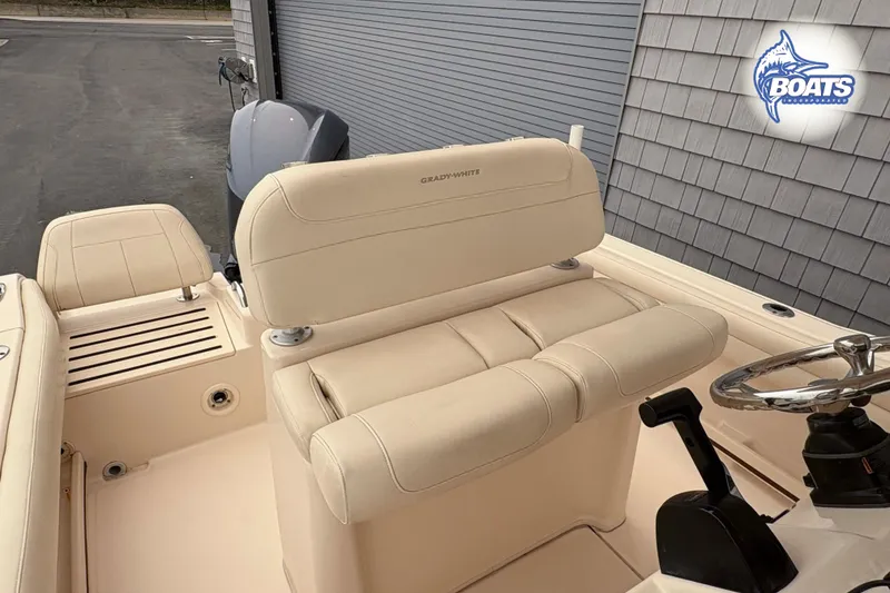 Slide: The Image of 2018 Grady-White Fisherman 216 boat interior with beige seating and steering wheel. - 7