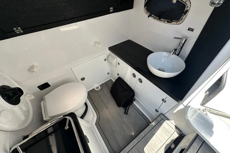 Slide: The Image of Luxurious bathroom interior of 2027 Monterey Elite 30 OB boat, featuring modern sink and toilet. - 13