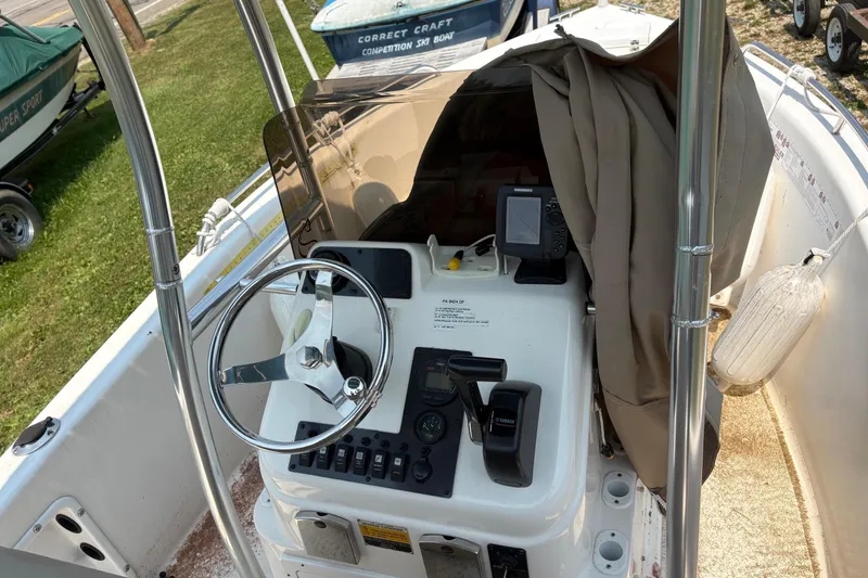 Slide: The Image of 2011 Clearwater 1900 Center Console boat interior with steering wheel and navigation equipment. - 1