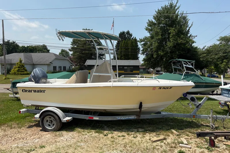 Slide: The Image of 2011 Clearwater 1900 Center Console boat on trailer, parked outdoors. - 0