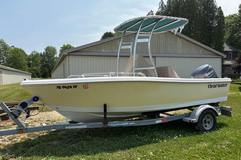 Slide: The Image of 2011 Clearwater 1900 Center Console boat on trailer, parked outdoors. - 3
