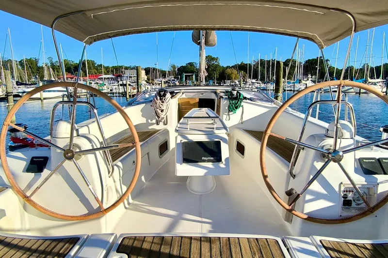 Slide: The Image of 2011 Beneteau Oceanis 40 sailboat cockpit with dual steering wheels, docked at marina. - 9
