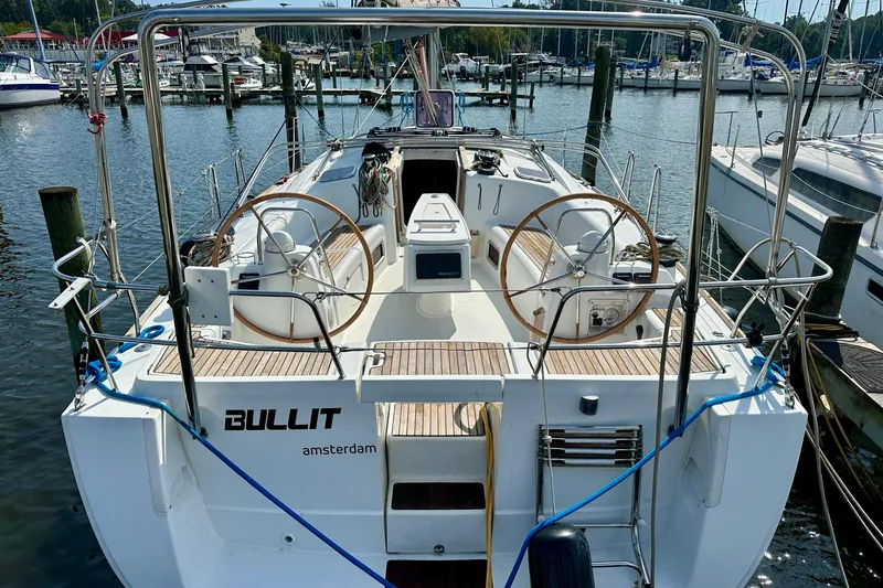 Slide: The Image of Beneteau Oceanis 40 sailboat, 2010 model, docked at a marina with dual steering wheels. - 0
